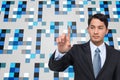 Composite image of asian businessman pointing Royalty Free Stock Photo
