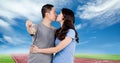 Composite image of asian couple holding house keys kissing against sports track and blue sky Royalty Free Stock Photo