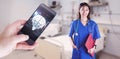 Composite image of asian nurse with stethoscope looking at the camera Royalty Free Stock Photo