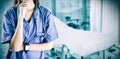 Composite image of asian nurse thinking with hand on chin Royalty Free Stock Photo