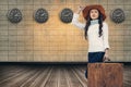 Composite image of asian woman with hat holding luggage Royalty Free Stock Photo