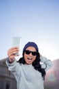 Composite image of asian woman taking selfie Royalty Free Stock Photo