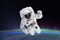 Composite image of astronaut floating in space, earth planet in the background, Elements of this image are furnished by NASA