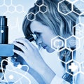 Composite image of attractive blonde scientist looking through a microscope Royalty Free Stock Photo