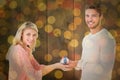 Composite image of attractive couple holding miniature house model Royalty Free Stock Photo