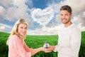 Composite image of attractive couple holding miniature house model Royalty Free Stock Photo