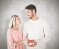 Composite image of attractive couple holding miniature house model Royalty Free Stock Photo