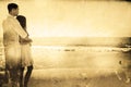 Composite image of attractive couple looking out at sea Royalty Free Stock Photo