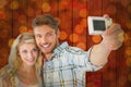 Composite image of attractive couple taking a selfie together Royalty Free Stock Photo