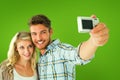 Composite image of attractive couple taking a selfie together Royalty Free Stock Photo