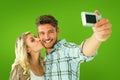 Composite image of attractive couple taking a selfie together Royalty Free Stock Photo