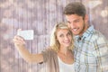 Composite image of attractive couple taking a selfie together Royalty Free Stock Photo