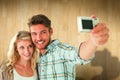 Composite image of attractive couple taking a selfie together Royalty Free Stock Photo