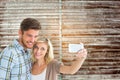 Composite image of attractive couple taking a selfie together Royalty Free Stock Photo