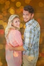 Composite image of attractive couple turning and smiling at camera Royalty Free Stock Photo