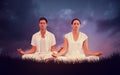 Composite image of attractive couple in white meditating in lotus pose Royalty Free Stock Photo