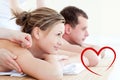 Composite image of attractive young couple having an acupunctre therapy