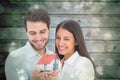 Composite image of attractive young couple holding a model house Royalty Free Stock Photo