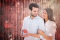 Composite image of attractive young couple holding a model house Royalty Free Stock Photo