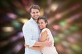 Composite image of attractive young couple hugging and smiling at camera Royalty Free Stock Photo