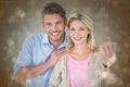Composite image of attractive young couple showing new house key Royalty Free Stock Photo