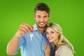 Composite image of attractive young couple showing new house key Royalty Free Stock Photo