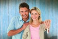 Composite image of attractive young couple showing new house key Royalty Free Stock Photo