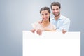 Composite image of attractive young couple smiling at camera Royalty Free Stock Photo