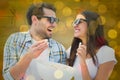 Composite image of attractive young couple watching a 3d movie Royalty Free Stock Photo