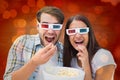 Composite image of attractive young couple watching a 3d movie Royalty Free Stock Photo