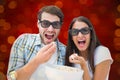 Composite image of attractive young couple watching a 3d movie Royalty Free Stock Photo