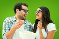 Composite image of attractive young couple watching a 3d movie Royalty Free Stock Photo