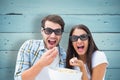 Composite image of attractive young couple watching a 3d movie Royalty Free Stock Photo