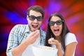 Composite image of attractive young couple watching a 3d movie Royalty Free Stock Photo