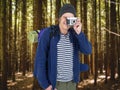 Composite image of backpacker hipster taking pictures with a retro camera Royalty Free Stock Photo