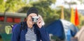 Composite image of backpacker hipster taking pictures with a retro camera Royalty Free Stock Photo