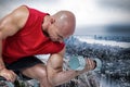Composite image of bald man exercising with dumbbells while sitting on bench press Royalty Free Stock Photo