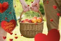 Composite image of basket of apples being carried by a young couple