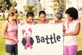 Composite image of battle text with female likeness and breast cancer awareness ribbon