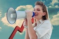 Composite image of beautiful businesswoman shouting through megaphone Royalty Free Stock Photo