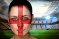 Composite image of beautiful england fan in face paint