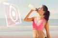 Composite image of beautiful healthy woman drinking water on beach