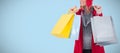 Composite image of blonde in winter clothes holding shopping bags Royalty Free Stock Photo