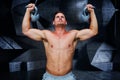 Composite image of bodybuilder holding kettlebells