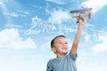 Composite image of boy holding toy airplane Royalty Free Stock Photo