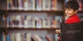 Composite image of boy sitting in wheelchair in school Royalty Free Stock Photo