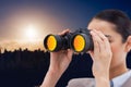 Composite image of brunette businesswoman looking through binoculars Royalty Free Stock Photo