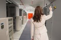 Composite image of brunette businesswoman standing back to camera Royalty Free Stock Photo