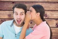 Composite image of brunette whispering secret to her boyfriend