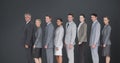 Composite image of business team standing in row and smiling at camera Royalty Free Stock Photo